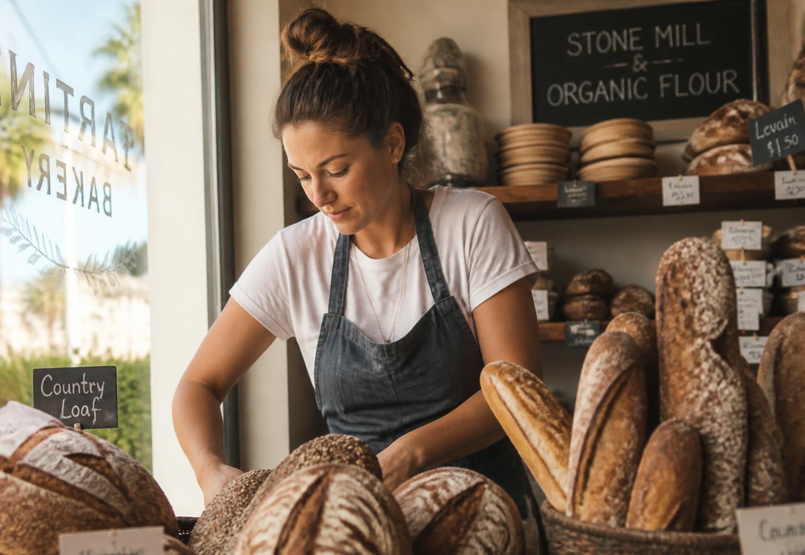 A small business owner standing in the doorway of their California shop